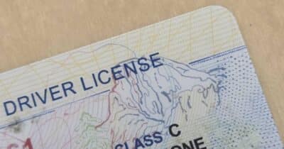 Checking an ID at auto dealership to prevent fraud